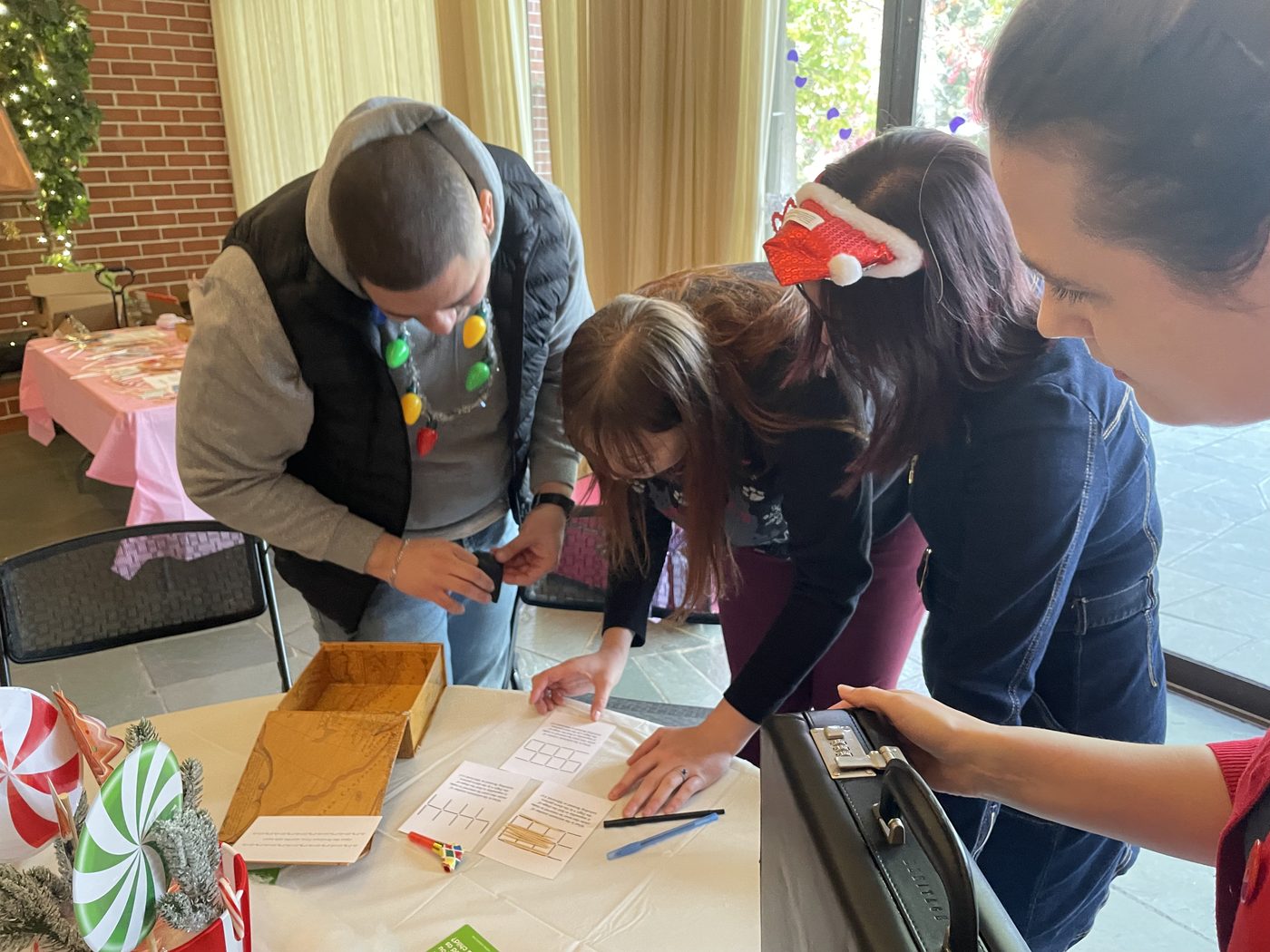 Participants compare paper clues and puzzle objects around a table
