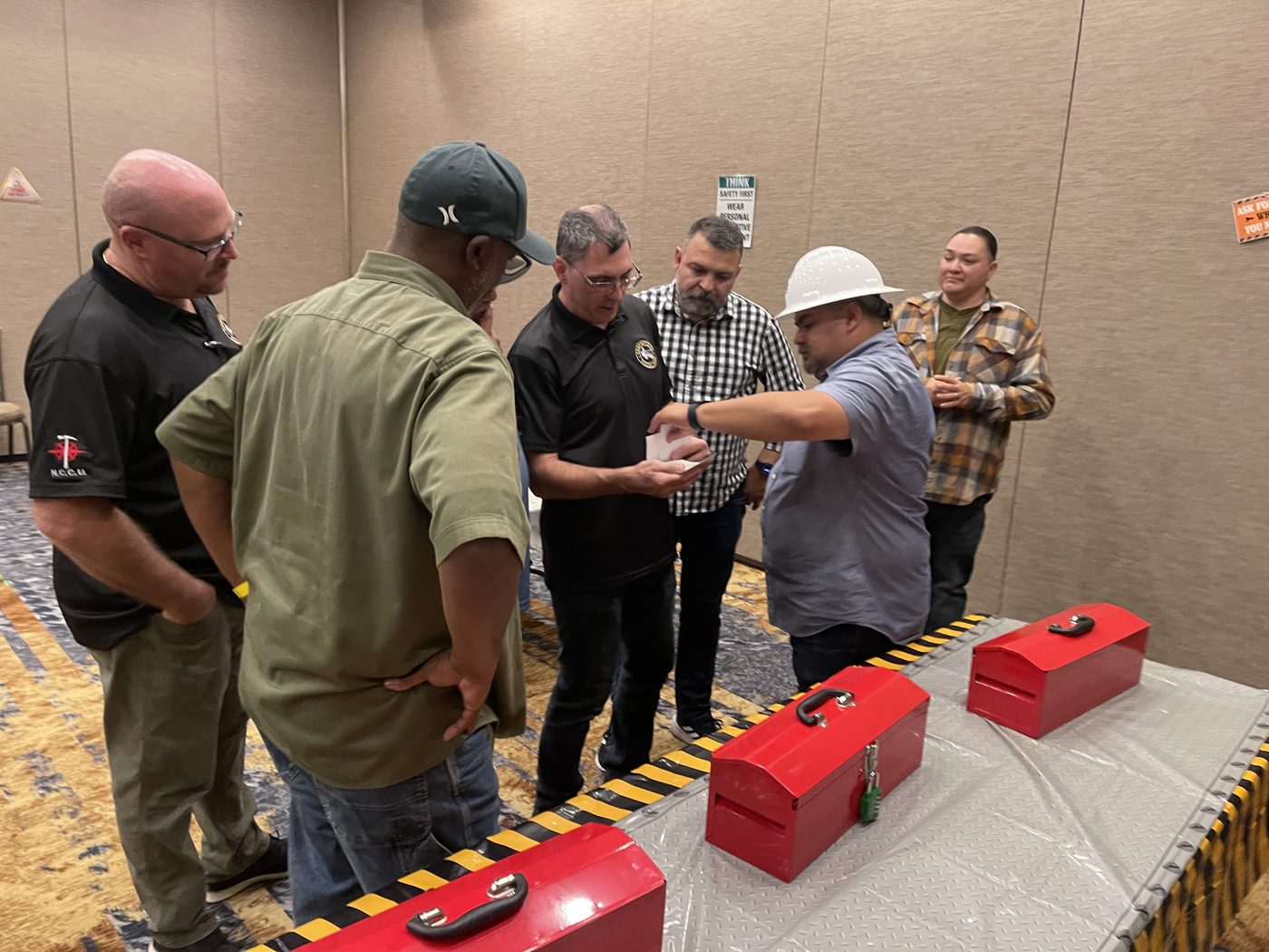 An event informant shares information beside locked red boxes